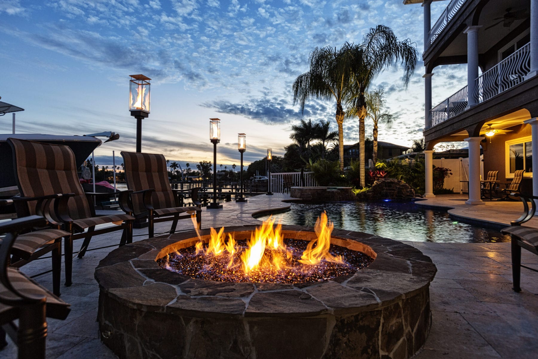 Beautiful swimming pool with fire pit and early morning sun in the tropics.